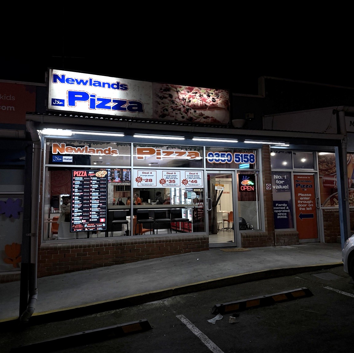 Newlands Pizza shopfront at night