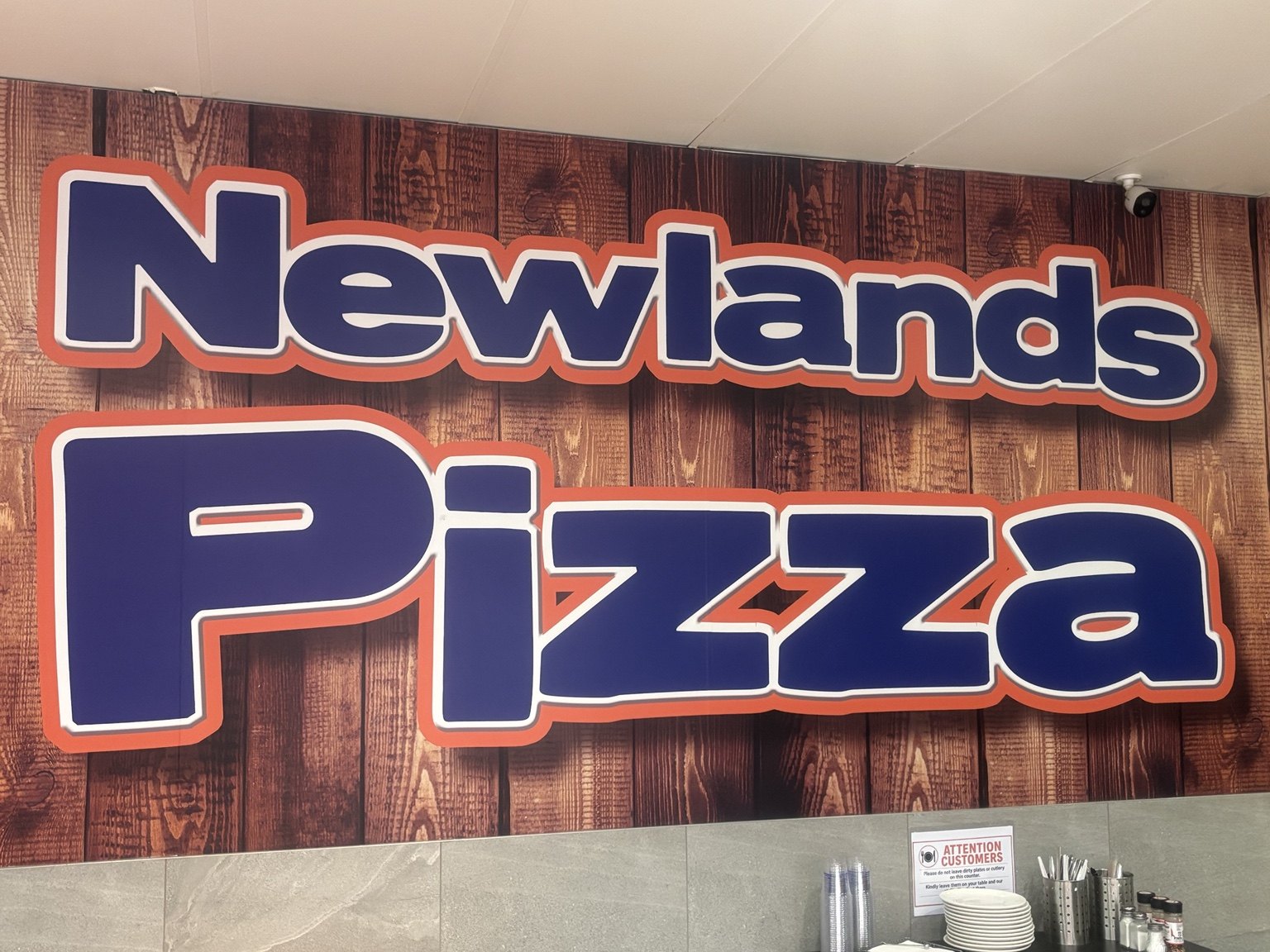 Newlands Pizza wall sign inside the restaurant